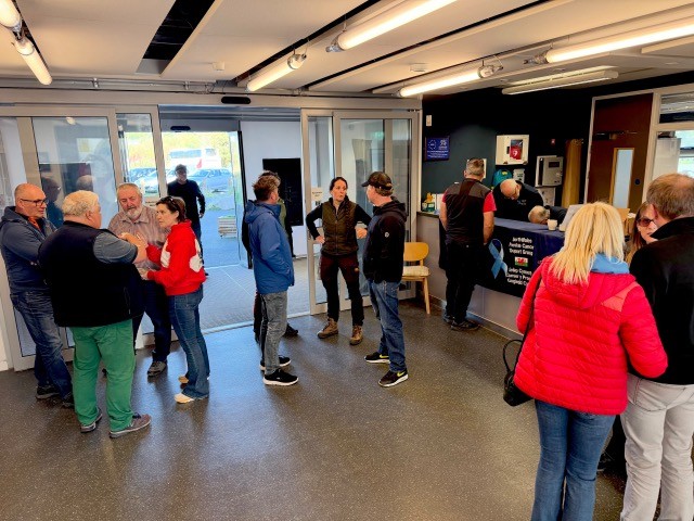 People gather in the foyer at Plas Heli, Pwllheli for the event